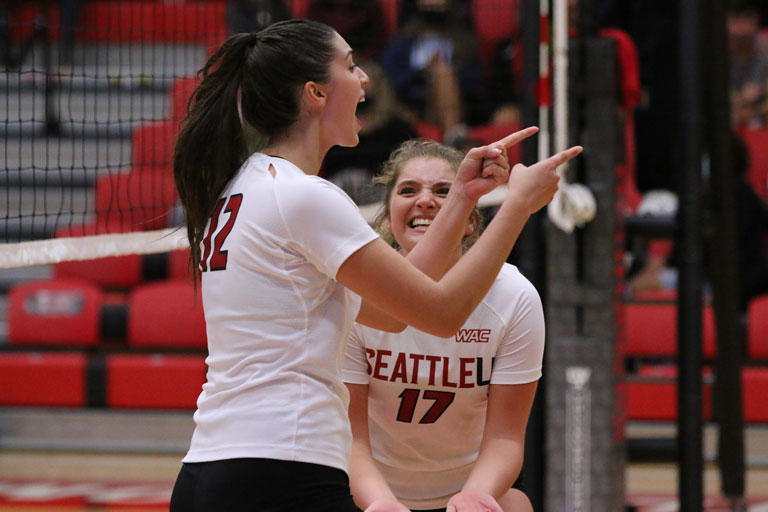   Sophia Sanchez, ’22 and Lauren McCabe, ’23 celebrate a point in a match on the court.